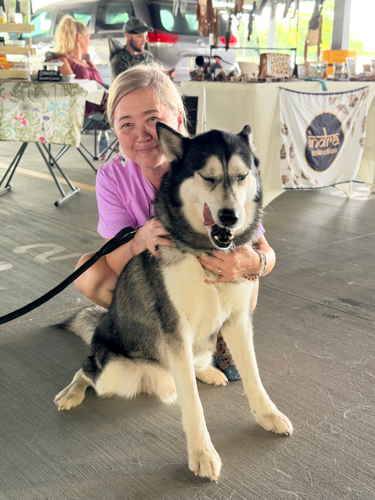Marie from Missy Liu’s with daycare dog Duke at the Rogers Farmers Market.