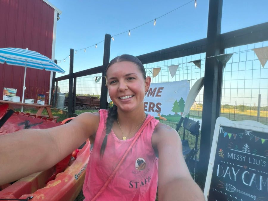 Rilyn, a Missy Liu’s staff member, helping care for dogs at daycare in Farmington, Arkansas